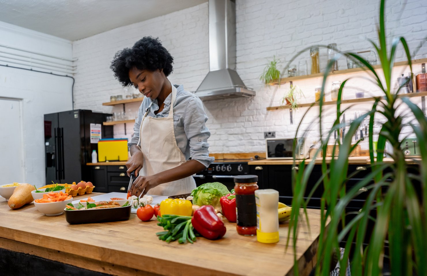 African American woman cooking a healthy meal at home